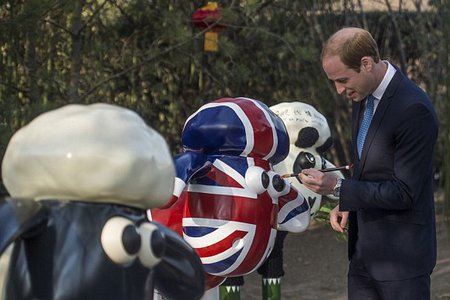 prince william painting a sheep sculpture