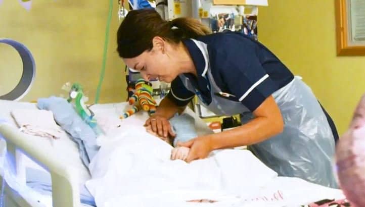 baby with nurse in hospital