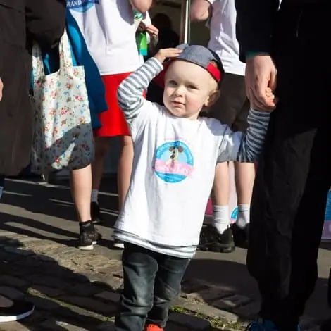 child wearing a cots for tots t-shirt