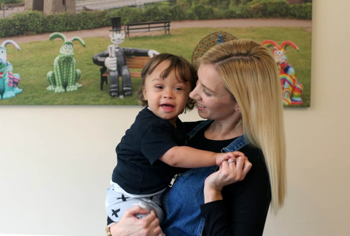 boy being held by mother