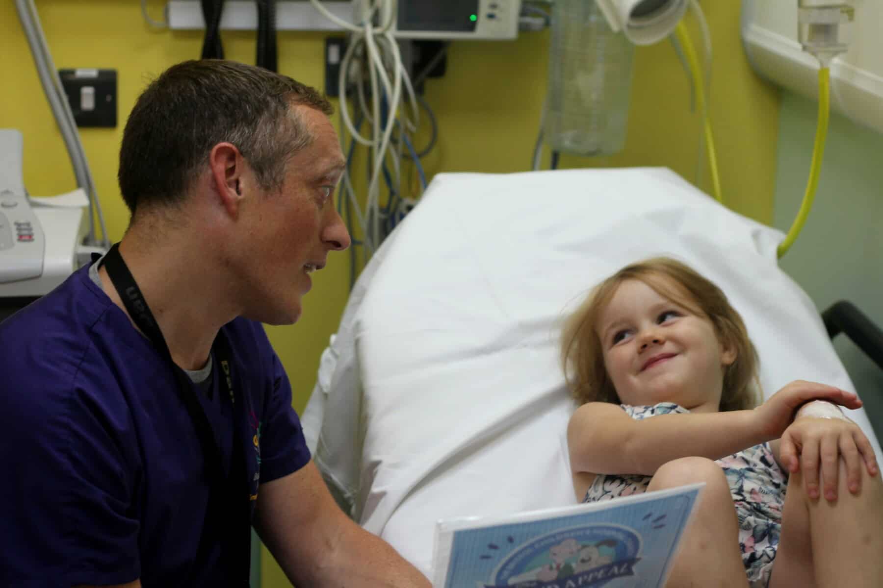 a doctor reading to a patient