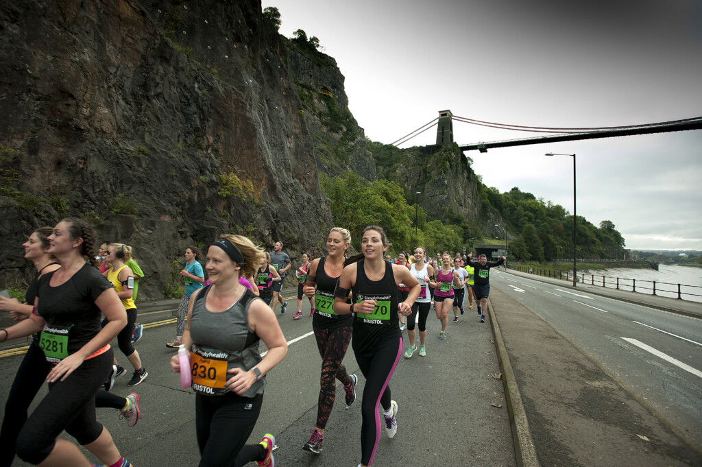 Women running under Clifton Suspension Bridge
