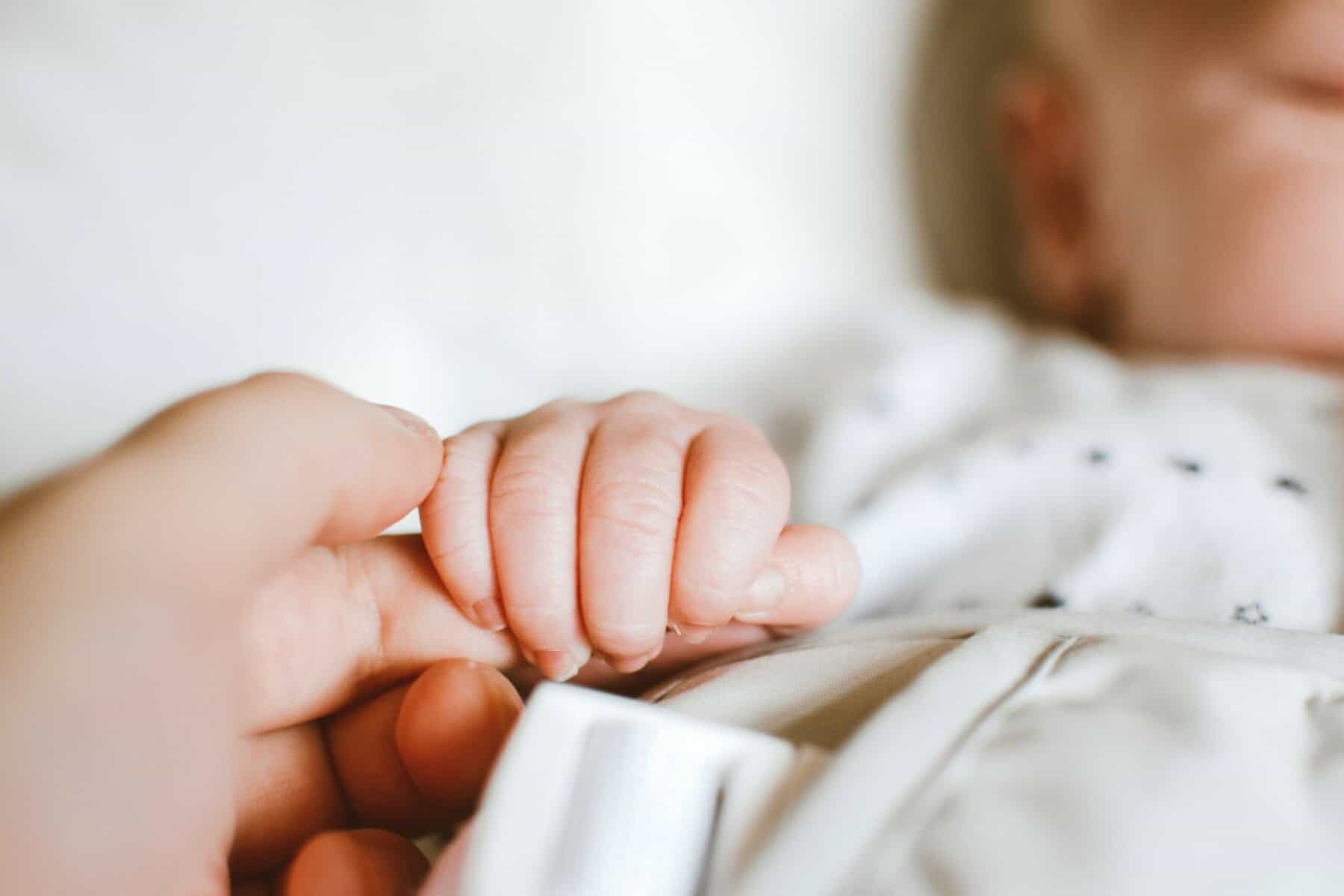 baby holding finger