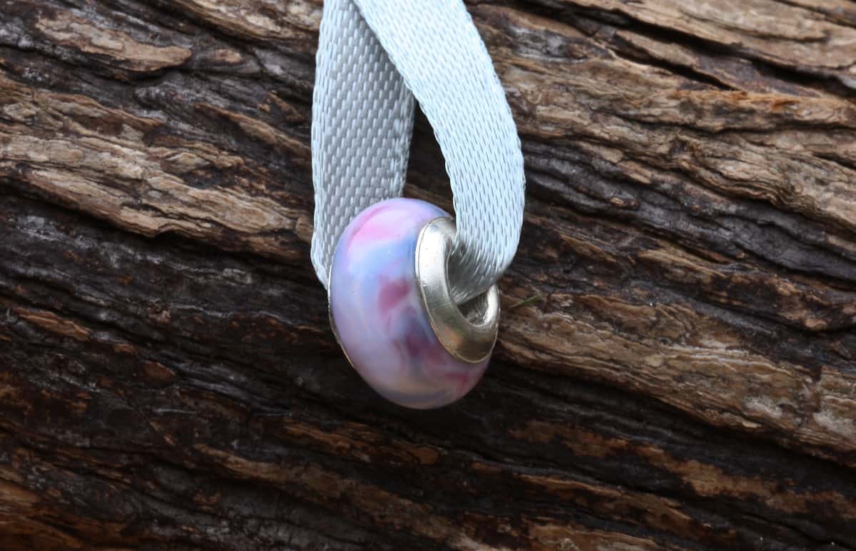 A decorative bead displayed on a tree