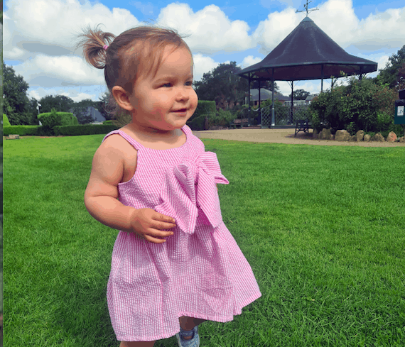 A young girl stood in a park