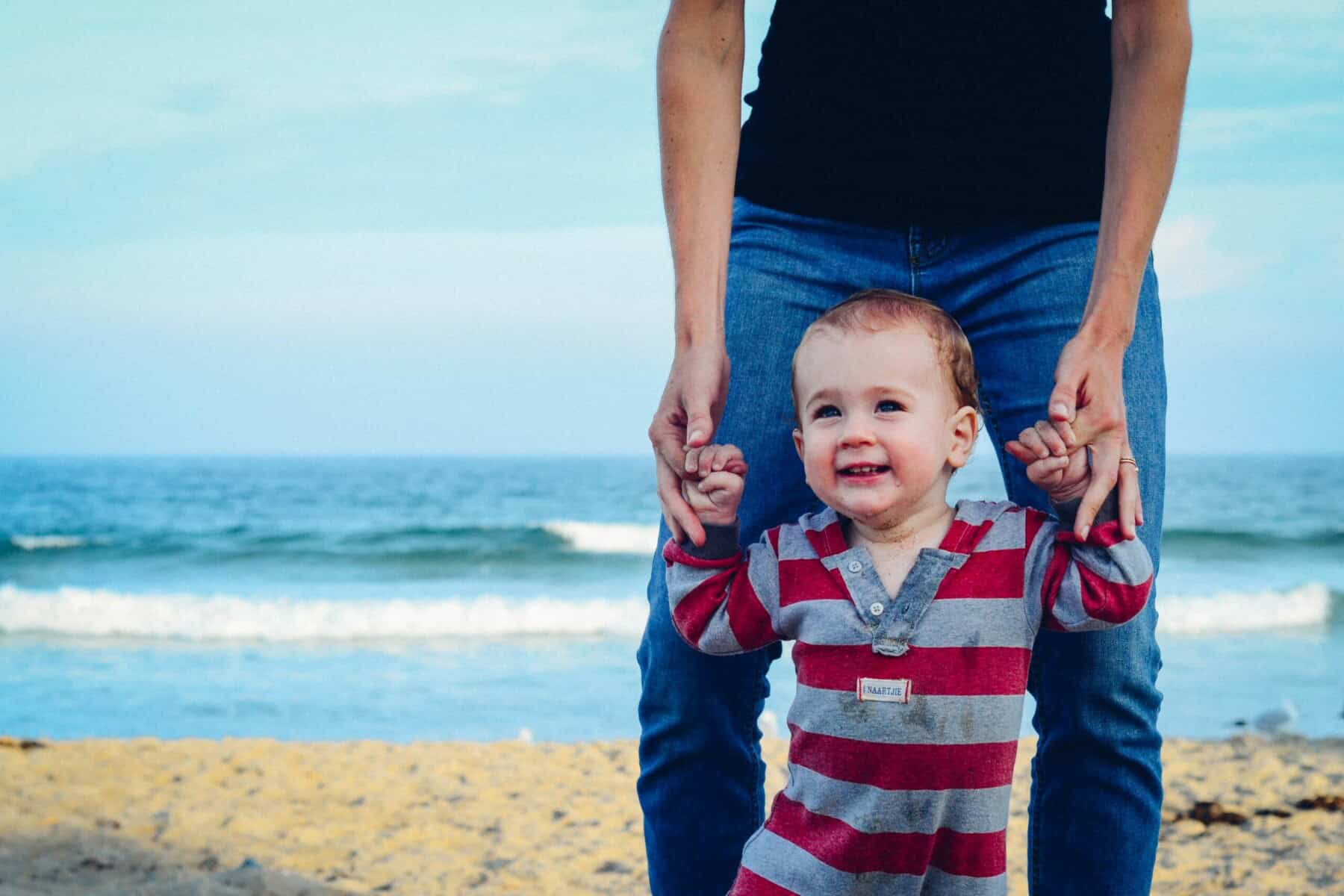 Parent holding their child on the beach