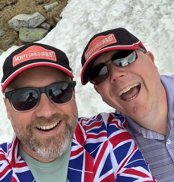 Dave and Gary dressed in Union Jack suits and shorts, with snow behind them.