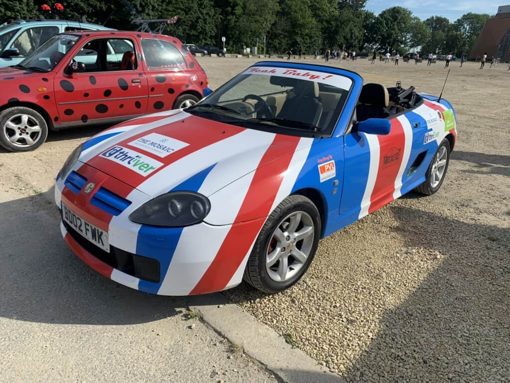 An image of a bust rally car painted as a Union Jack.