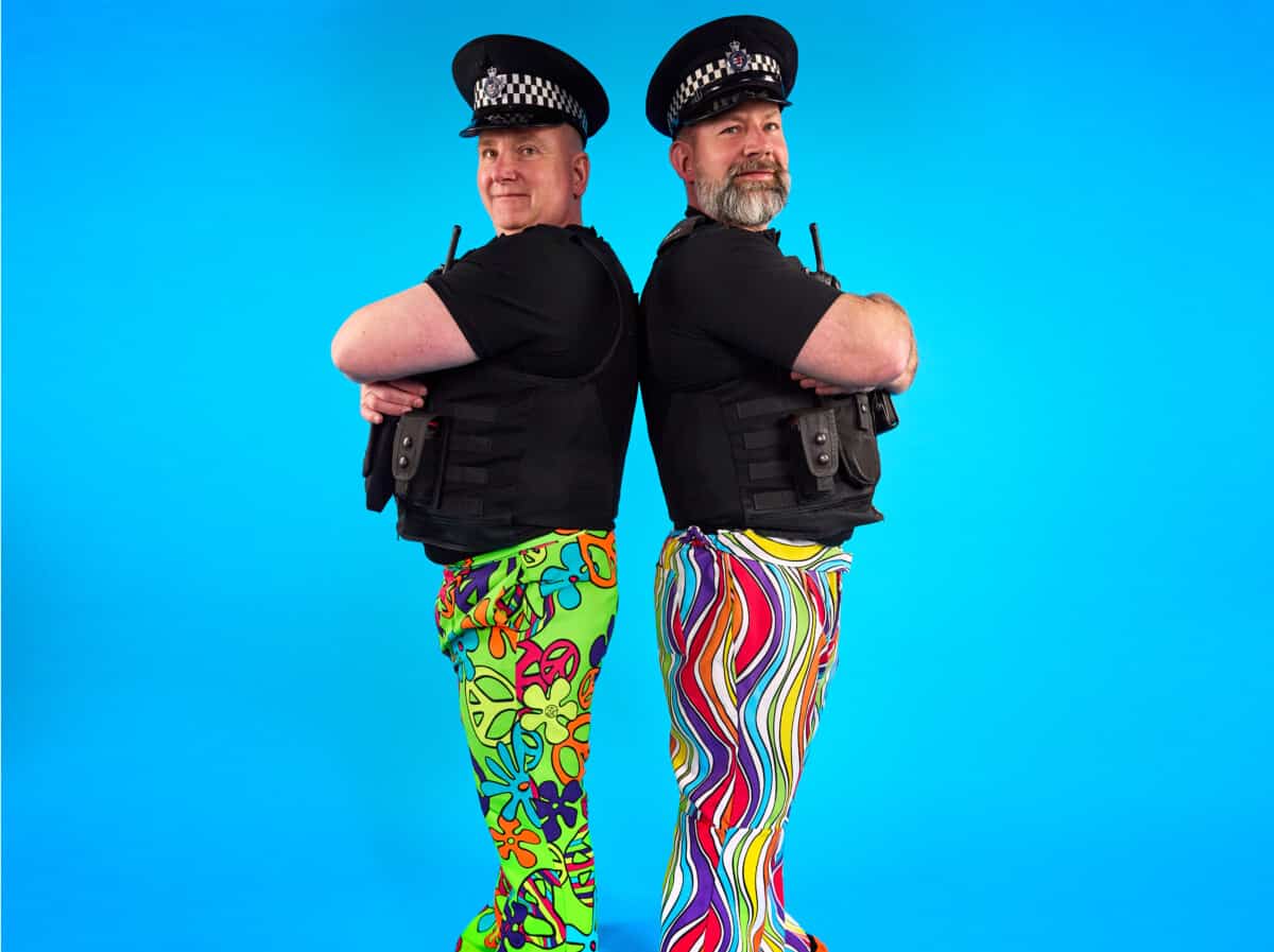 Two policemen at work joining in wrong trousers day event. Companies and corporates wear non-uniform to raise money for charity in Bristol. The photo is showing people can get involved in Wallace & Gromit's Wrong Trousers Day at work, through their company or corporate.