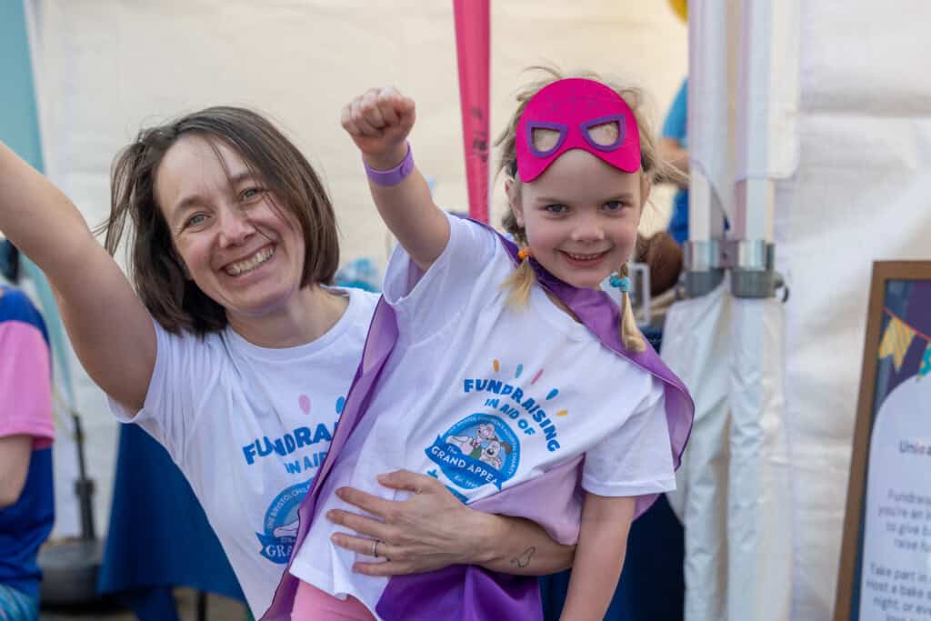 A mother and daughter doing superman pose after completing the Great Bristol Family Run 