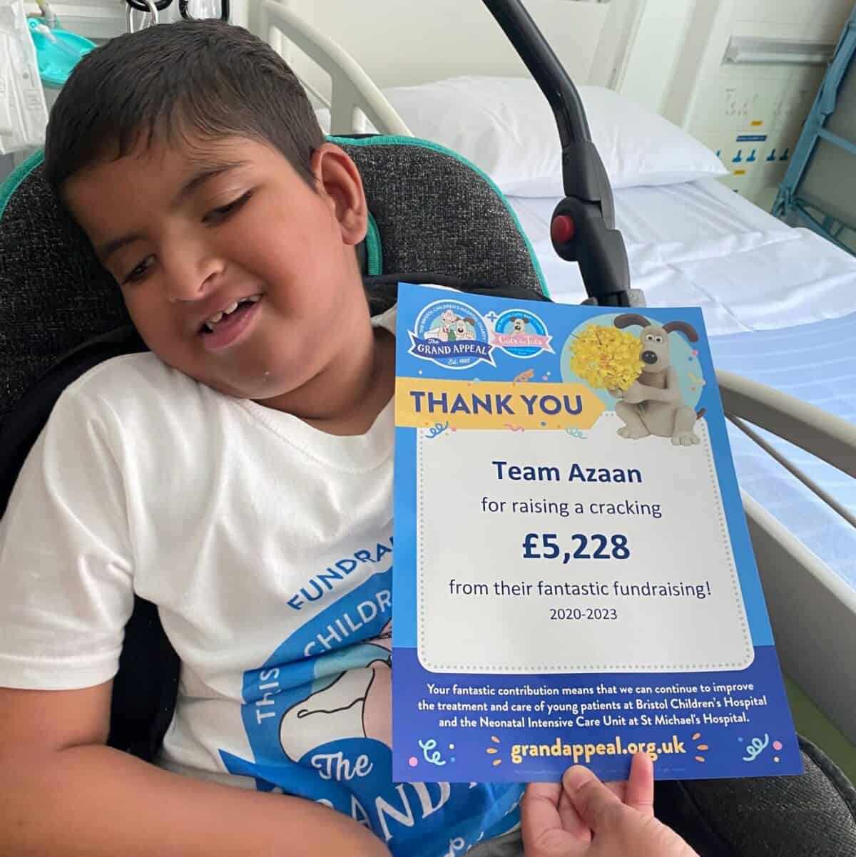 A child with a certificate at Bristol Children's Hospital.