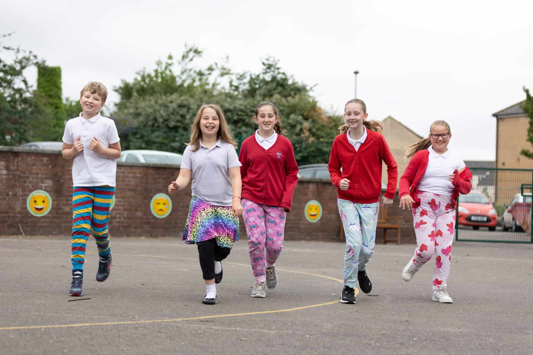 A group of school children in a playground.