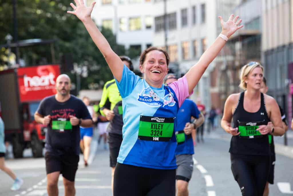 Woman happy running the 10k for The Grand Appeal