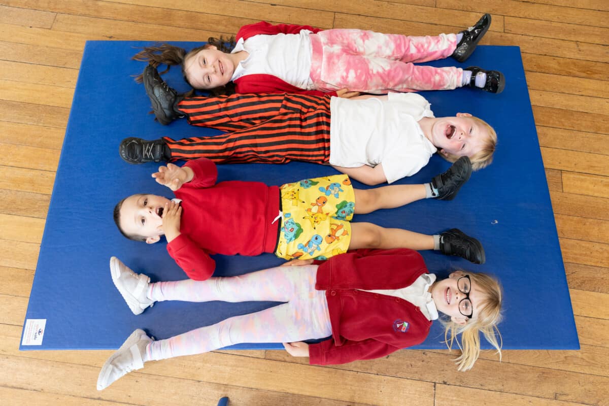 A group of children on a school mat.