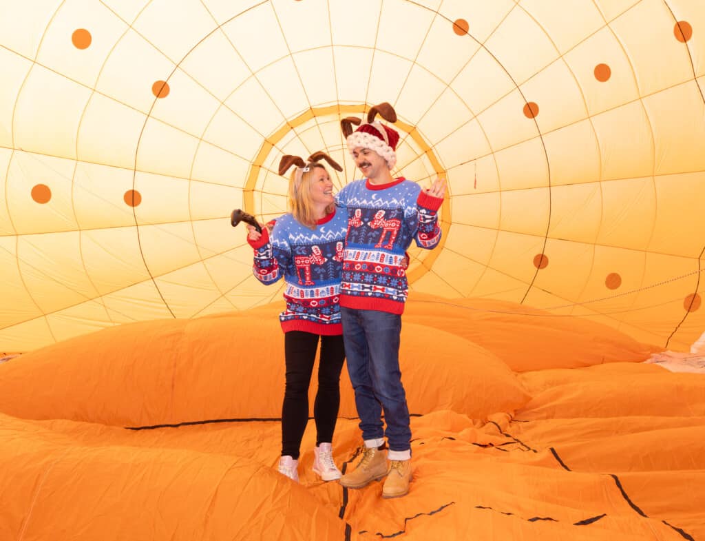 Two people inside the Wallace & Gromit's Moon Rocket hot air balloon.