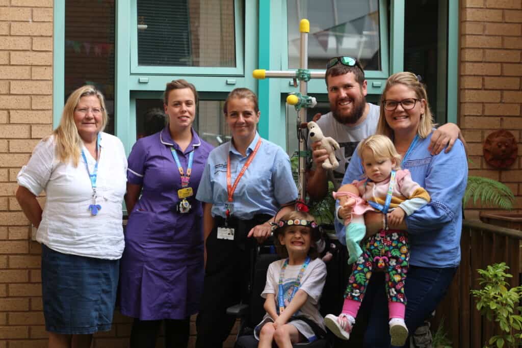 Archie in his Halo Wheelchair at with his family and staff at the Bristol Children's Hospital. 