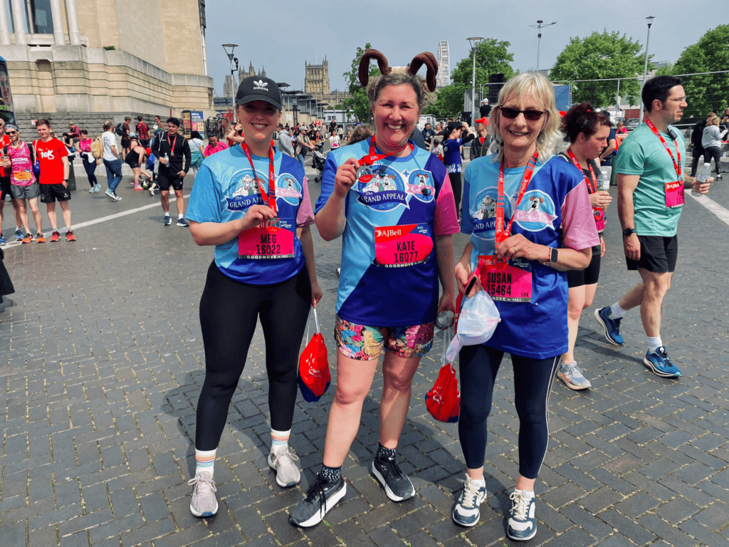 Meg pictured with her Bristol 10k medal. Beside her is a member of staff from the Grand Appeal and Alex's mum. 