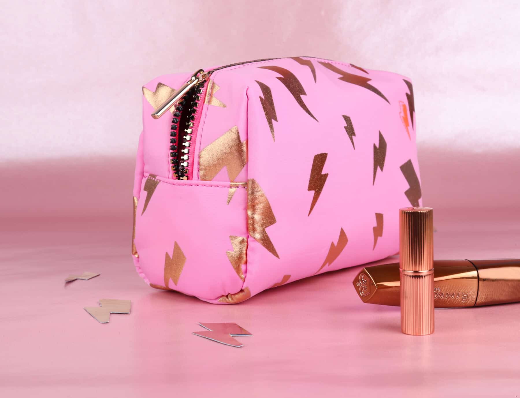 A Scamp & Dude makeup bag in pink with gold foil lightning bolts