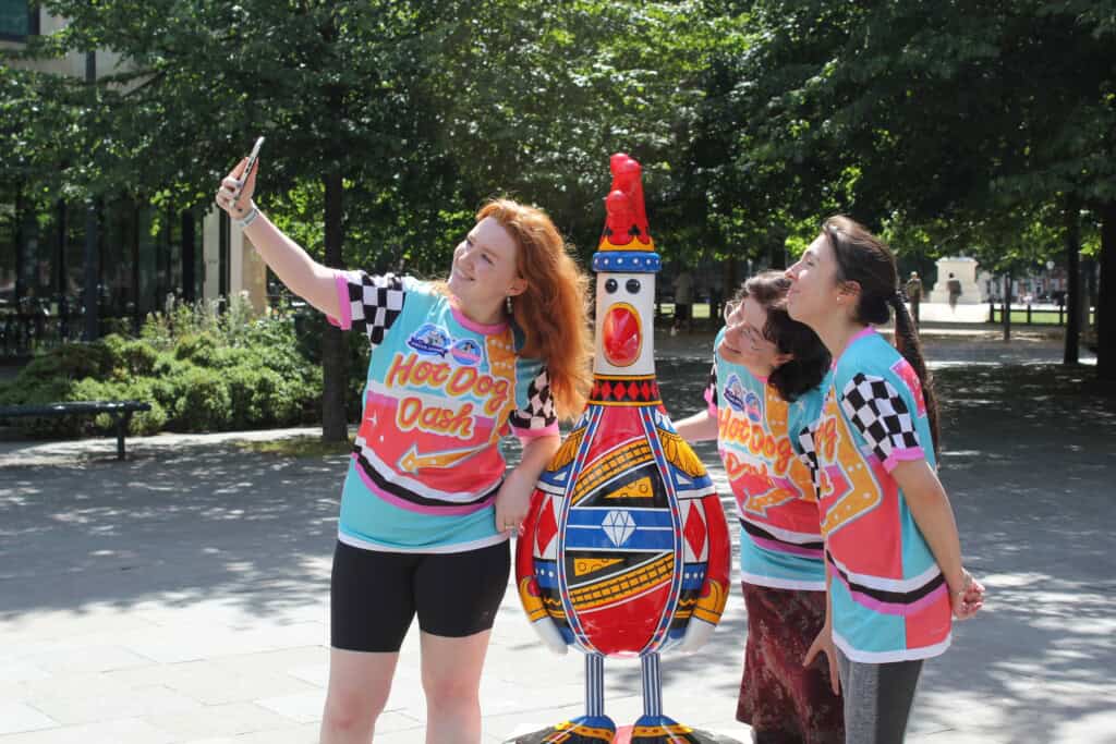 Runners passing multiple Gromit sculptures while taking part in the Hot Dog Dash challenge.