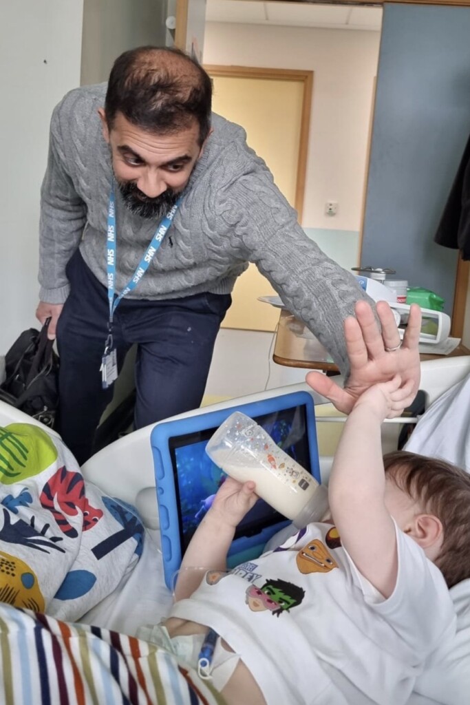 Miles high-fiving his surgeon, Dr. Shafi Mussa.