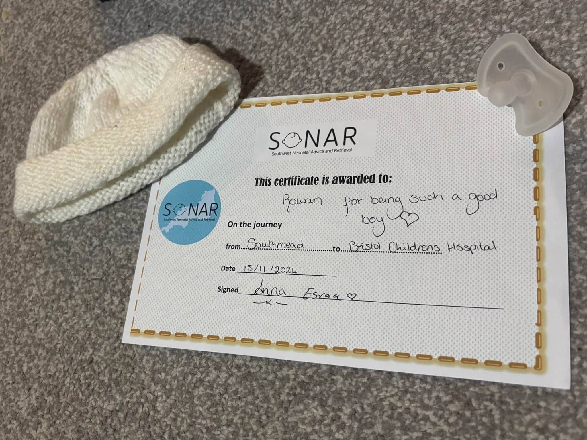 A photo of Rowan's SoNAR certificate, hat and dummy.